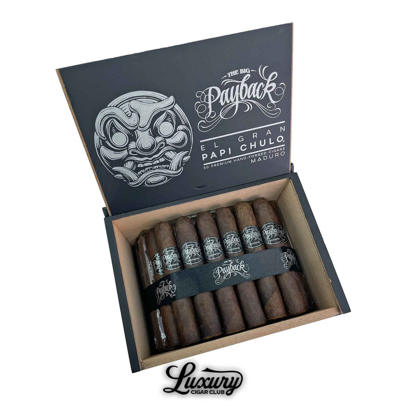 Open box of Room101 Big Payback Maduro Papi Chulo cigars featuring dark brown wrappers, silver branding, and a bold interior lid design with a stylized mask and “El Gran Papi Chulo” text.