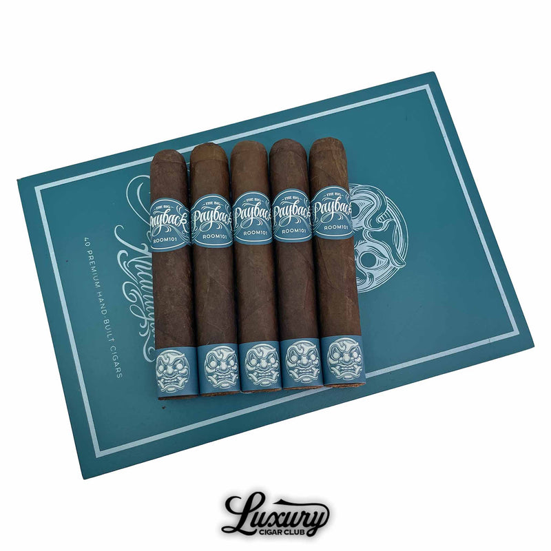 Five Room 101 Big Payback Nicaragua Robusto cigars displayed on top of the branded teal box, showcasing detailed teal and white cigar bands with artistic mask design, sold by Luxury Cigar Club.