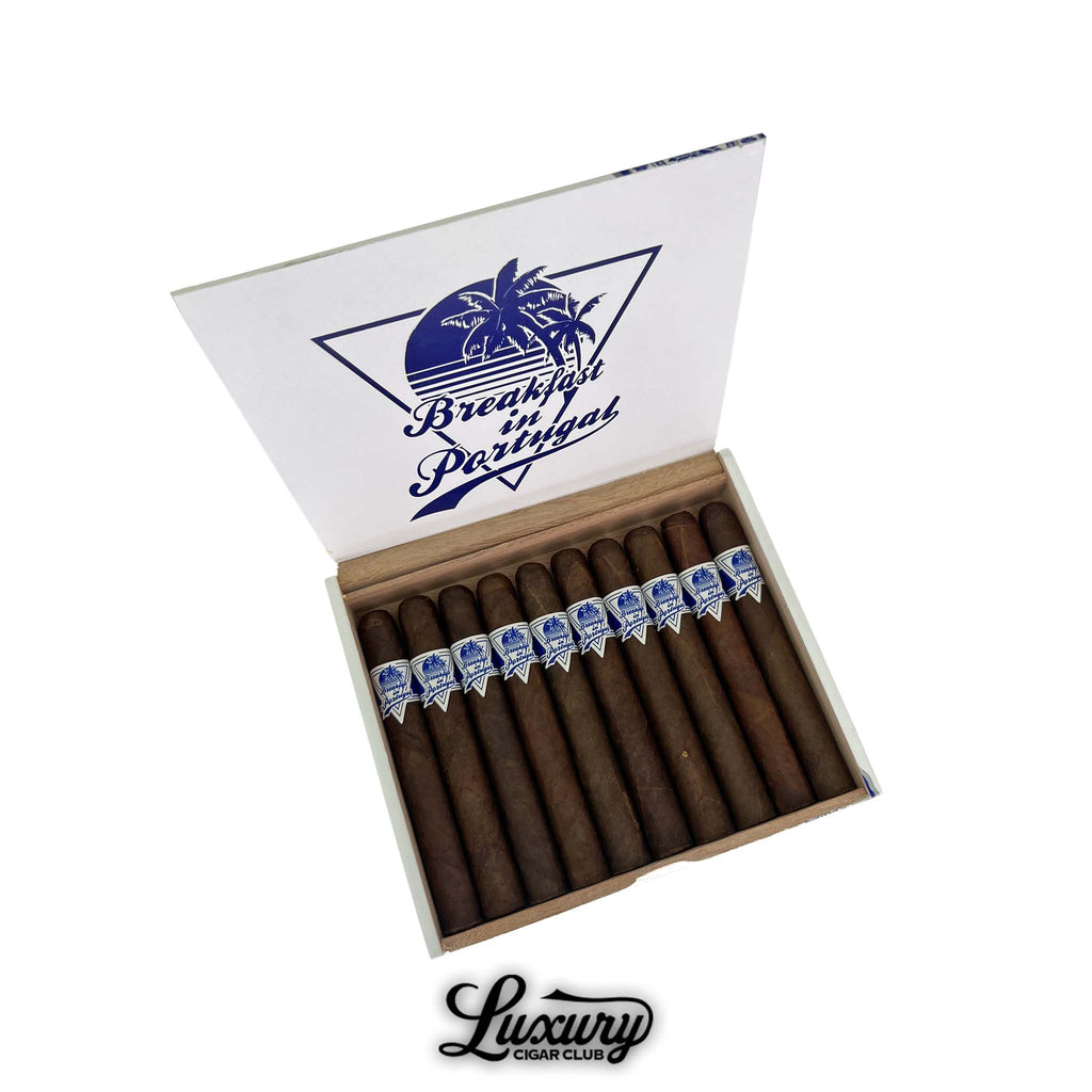 Room 101 Breakfast in Portugal Maduro Toro cigars box open, displaying a row of 10 dark brown premium cigars with blue and white bands featuring palm tree logo, presented by Luxury Cigar Club.