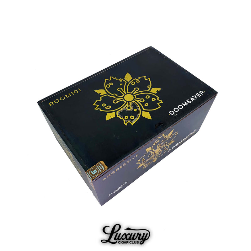 Closed Room101 Doomsayer Aggressive Maduro Toro Extra cigar box in navy blue with gold floral emblem and bold lettering, shown from above at Luxury Cigar Club.