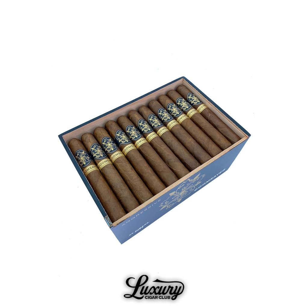 Full box view of Room101 Doomsayer Aggressive Maduro Toro Extra cigars with navy and gold bands, neatly arranged inside a branded wooden box at Luxury Cigar Club.