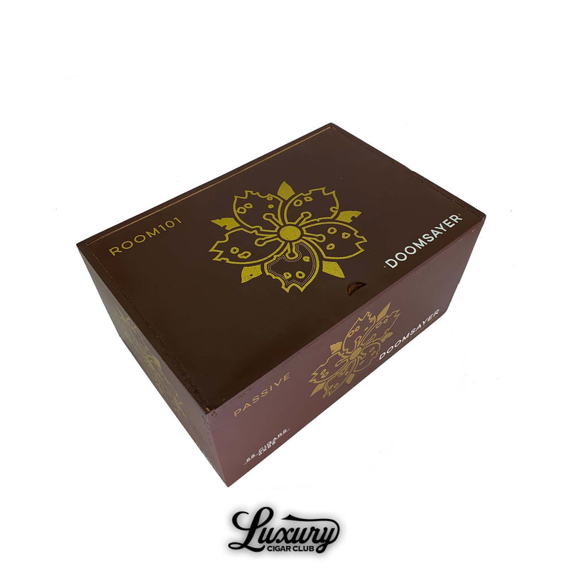 Closed Room101 Doomsayer Passive Claro cigar box in brown with gold floral logo and bold lettering on the lid.