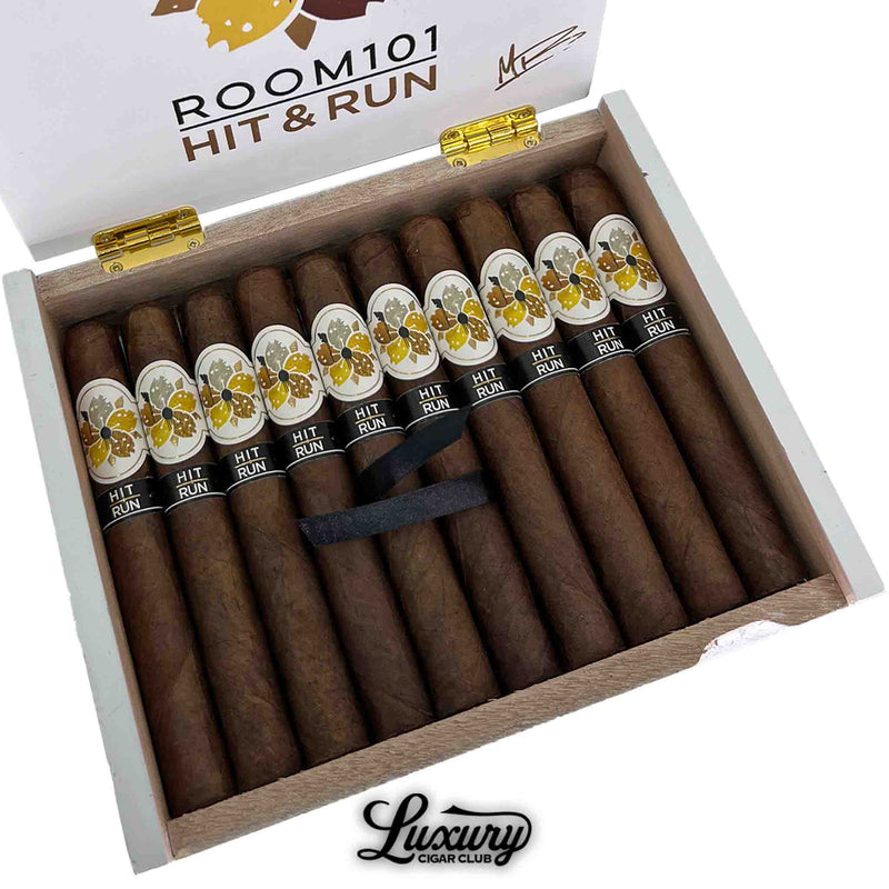 Room101 Hit and Run Toro cigars in white wooden box from Luxury Cigar Club with gold hinges and floral design on the lid displaying luxury presentation of premium handmade cigars