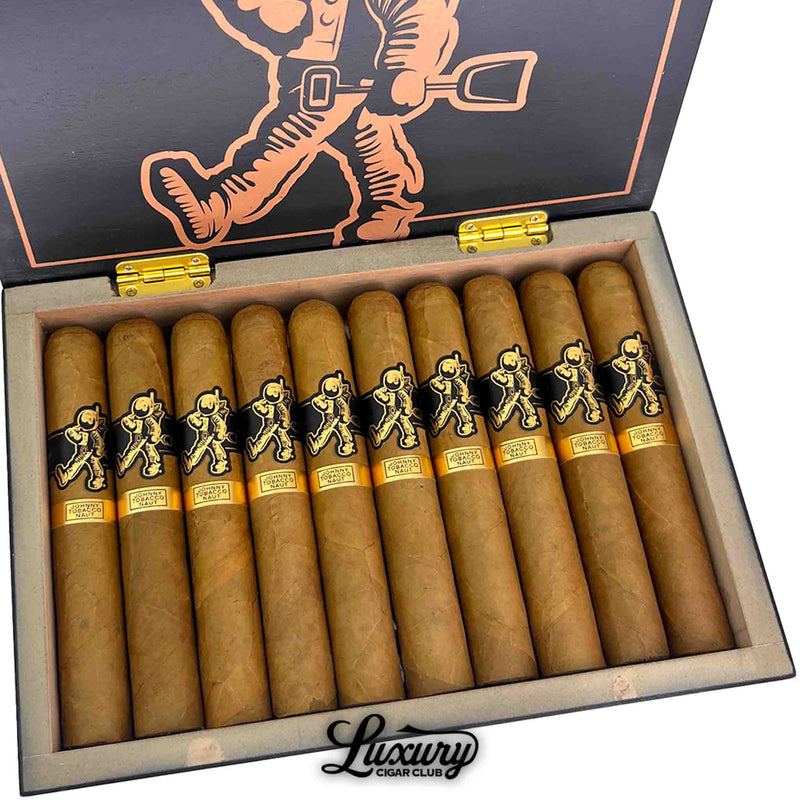 Close-up view of Room 101 Johnny Tobacconaut Gordo cigars arranged in a row inside the box, highlighting the golden foot bands, black-and-gold astronaut logo bands, and the detailed cigar wrapper texture.