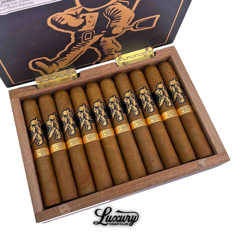 Close-up of an open box of Room101 Johnny Tobacconaut Robusto cigars, displaying 10 cigars with black and gold astronaut-themed bands. The inner lid features a large gold illustration of the Tobacconaut character, with the Luxury Cigar Club logo below the box.