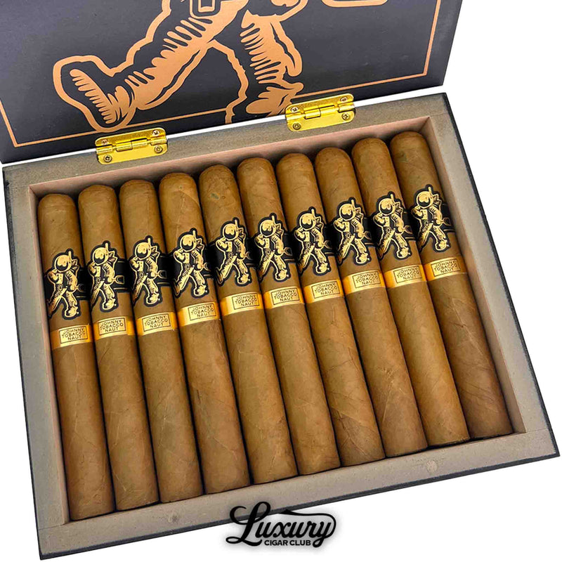 Close-up view of Room 101 Johnny Tobacconaut Toro cigars inside the open box, highlighting the smooth light-brown wrappers, black astronaut bands, and detailed gold labeling.