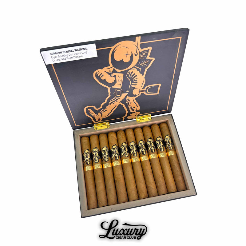 Room 101 Johnny Tobacconaut Toro cigars displayed in an open black and copper box featuring the astronaut logo, showing ten golden-brown toro cigars with black and gold bands arranged neatly inside.