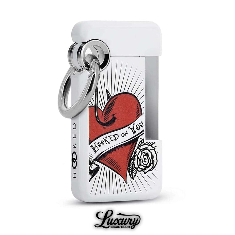 Elegant ST Dupont Hooked single jet lighter in white lacquer with red heart and rose tattoo artwork, inscribed with “Hooked on You,” perfect collector’s piece, sold by Luxury Cigar Club.