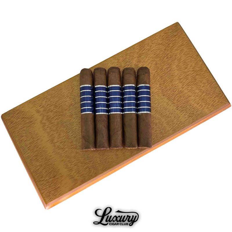 Close-up of Sans Pareil Blue Petite Corona cigars highlighting the refined blue striped bands and smooth wrapper, presented by Luxury Cigar Club.