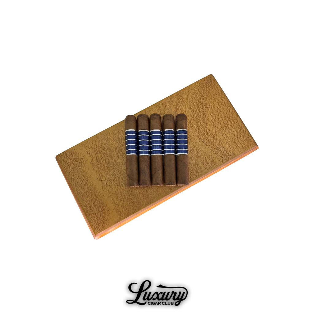 Sans Pareil Blue Petite Corona cigars neatly displayed on a wooden box, featuring sleek blue and silver bands, available at Luxury Cigar Club.