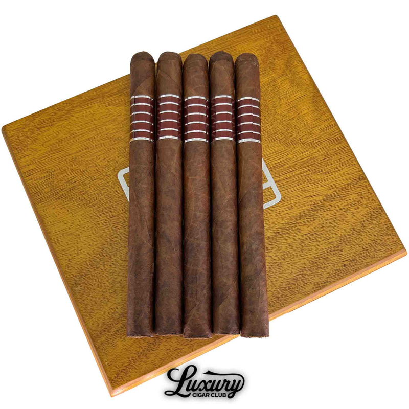 Close-up of Sans Pareil Red A cigars showing their rich color, smooth construction, and signature red-and-silver band design, featured by Luxury Cigar Club.