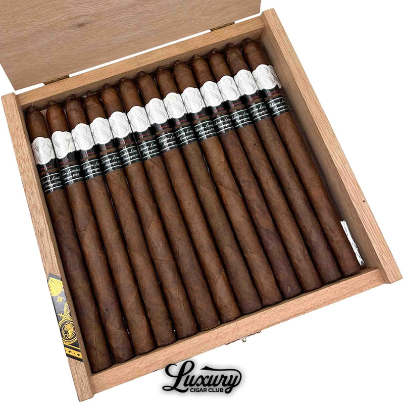 Close up view of Sencillo Black Limited Edition Lancero cigars showing dark brown wrappers and stylish black and white cigar bands inside wooden presentation box at Luxury Cigar Club