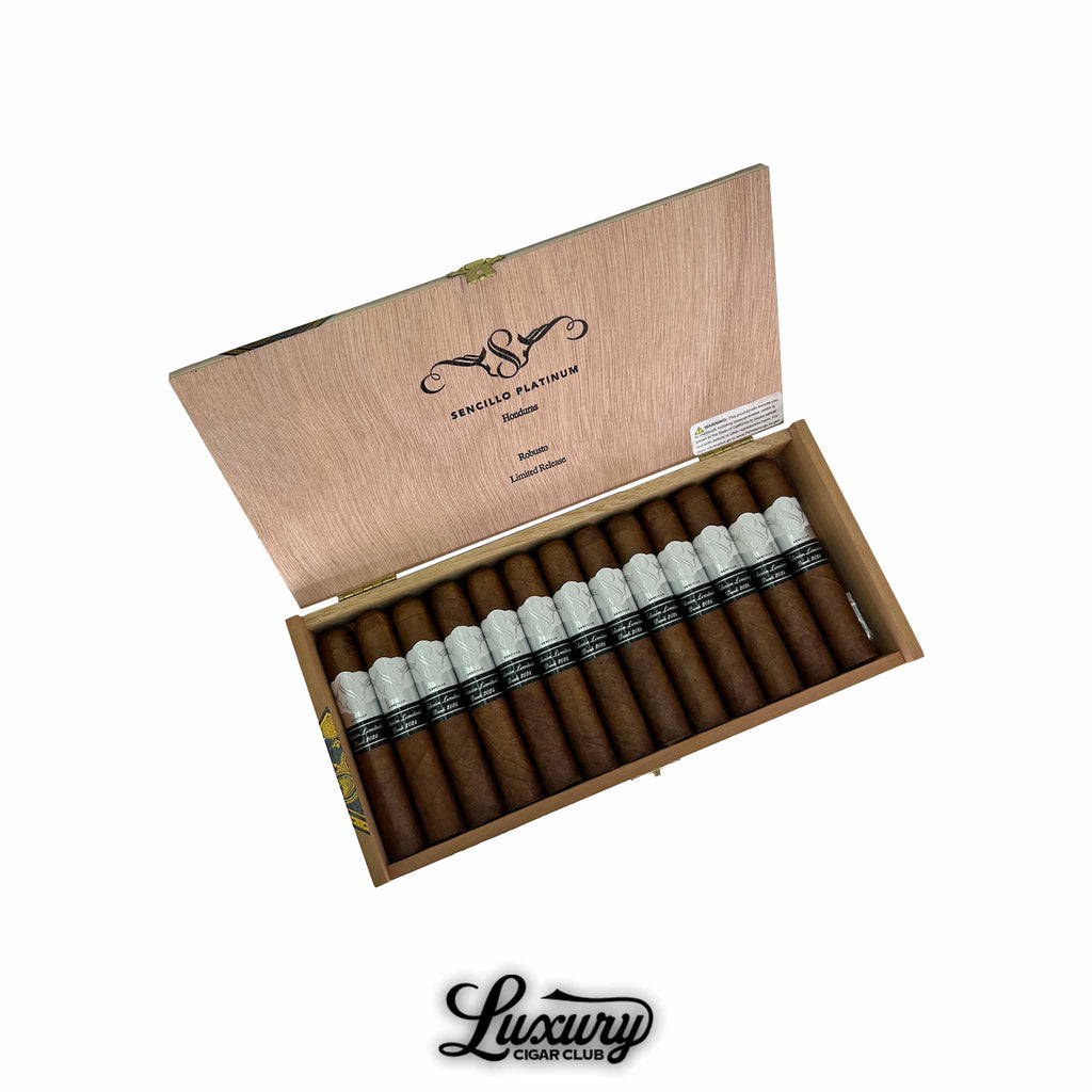 Open wooden box of Sencillo Platinum Robusto cigars with silver and black bands, displayed in a 20-count presentation from Luxury Cigar Club.