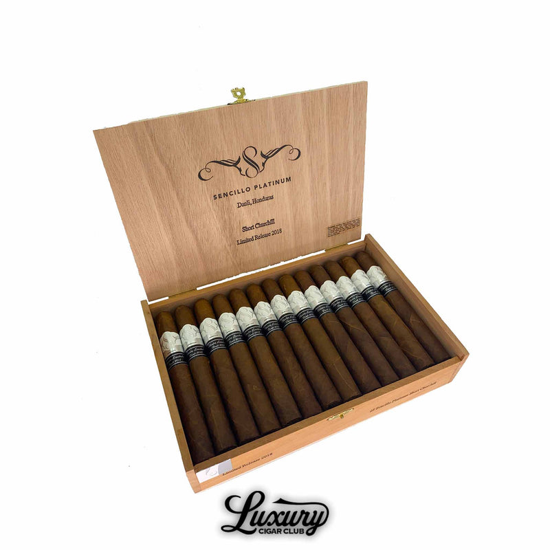 Open cedar box of Sencillo Platinum Short Churchill cigars from Honduras, Limited Release 2018, displayed with white and black bands. Luxury Cigar Club branding.