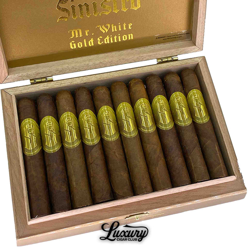 Close up of Sinistro Mr. White Gold Edition Robusto cigars inside open wooden box showing gold embossed bands and premium brown wrapper, photographed by Luxury Cigar Club