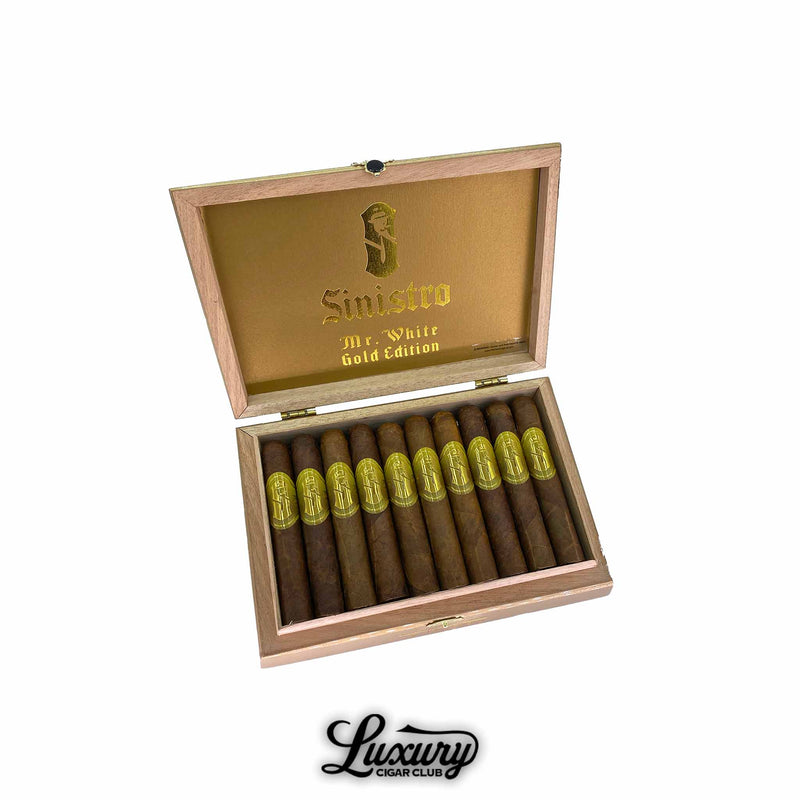 Open wooden cigar box displaying Sinistro Mr. White Gold Edition Robusto cigars with gold embossed bands, photographed by Luxury Cigar Club