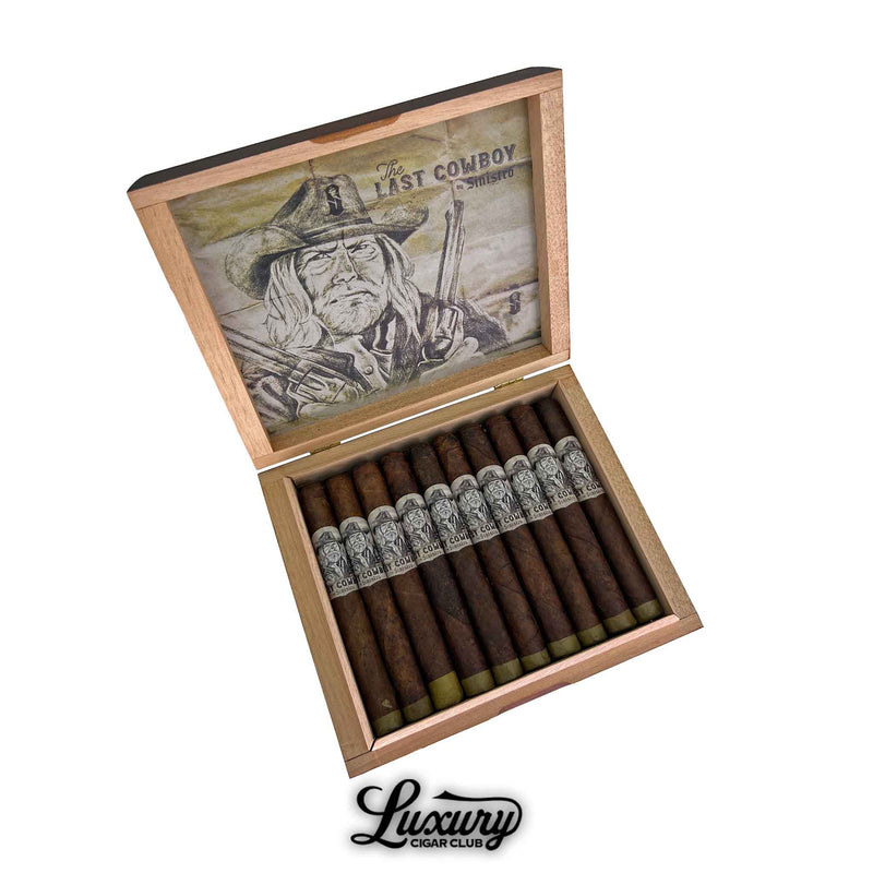 Open wooden cigar box displaying twelve Sinistro The Last Cowboy Maduro Corona cigars, each with a closed foot and a black-and-white cowboy-themed band. The inside lid features aged parchment-style artwork of a cowboy holding two pistols with the text “The Last Cowboy by Sinistro.” The Luxury Cigar Club logo appears below the box.