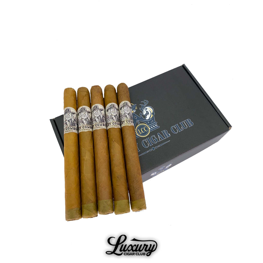 Sinistro The Last Cowboy Natural cigars arranged in a row on a Luxury Cigar Club box, showcasing light brown Connecticut wrappers with detailed cowboy-themed bands.