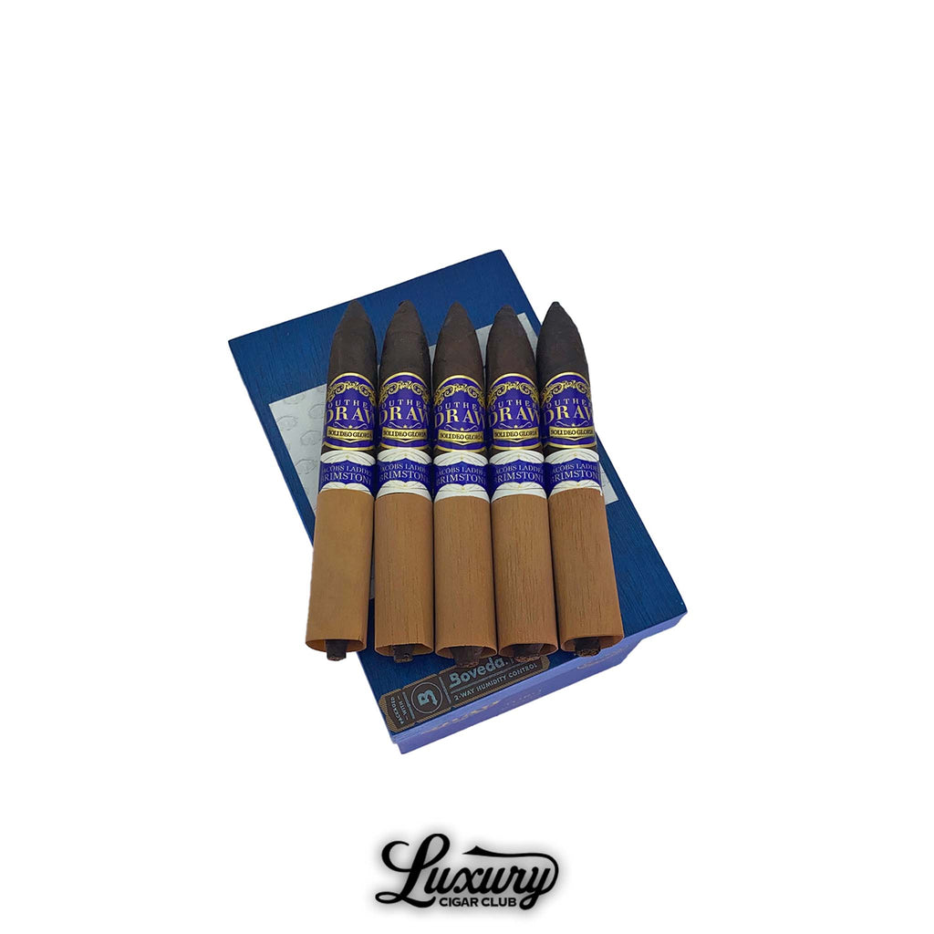 Luxury Cigar Club photo of Southern Draw Jacob’s Ladder Brimstone cigars resting on a blue box, each cigar wrapped in cedar with a pointed cap.