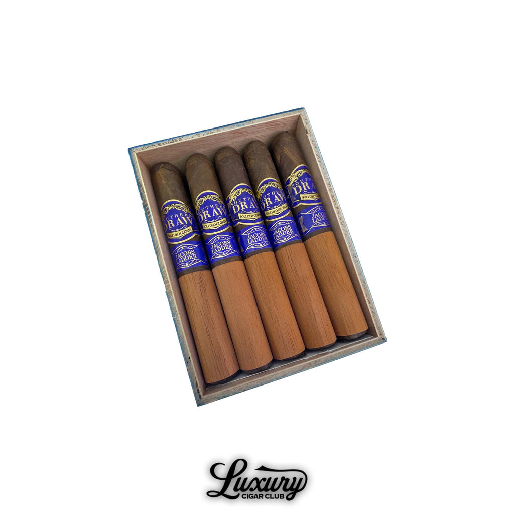 Open box of Southern Draw Jacobs Ladder Gordo cigars with blue and gold bands and cedar sleeves, displayed for sale at Luxury Cigar Club