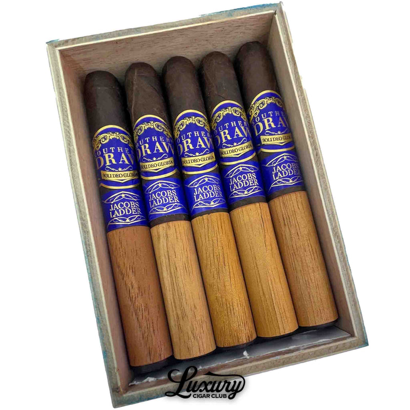 Tight close up of Southern Draw Jacobs Ladder Toro cigars in box, highlighting bold blue bands and cedar wrapping.