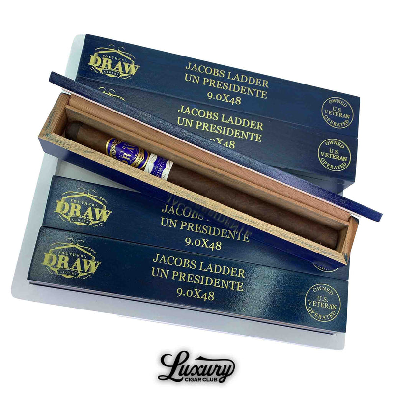 Southern Draw Jacobs Ladder Un Presidente long cigars in individual blue boxes, one box open showing the cigar inside white and gold branded sleeve.