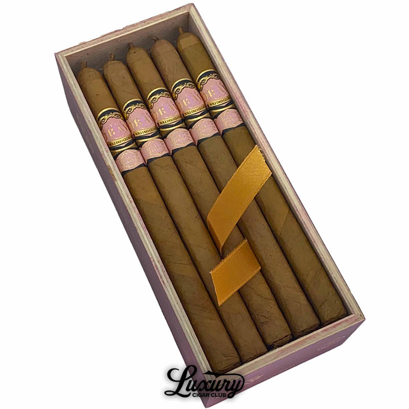 Close-up of Southern Draw Rose of Sharon Lancero cigars highlighting the delicate pink and gold bands and flawless wrapper, elegantly arranged with a satin ribbon inside the box, presented by Luxury Cigar Club.