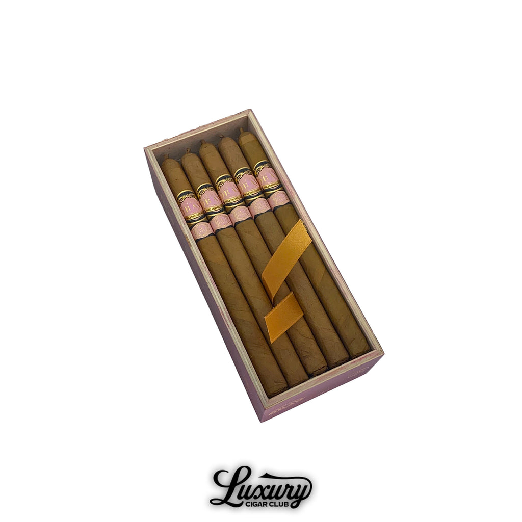 Southern Draw Rose of Sharon Lancero cigars presented in an elegant pink box, showcasing six slender cigars with soft Connecticut wrappers and gold ribbon accents, featured by Luxury Cigar Club.