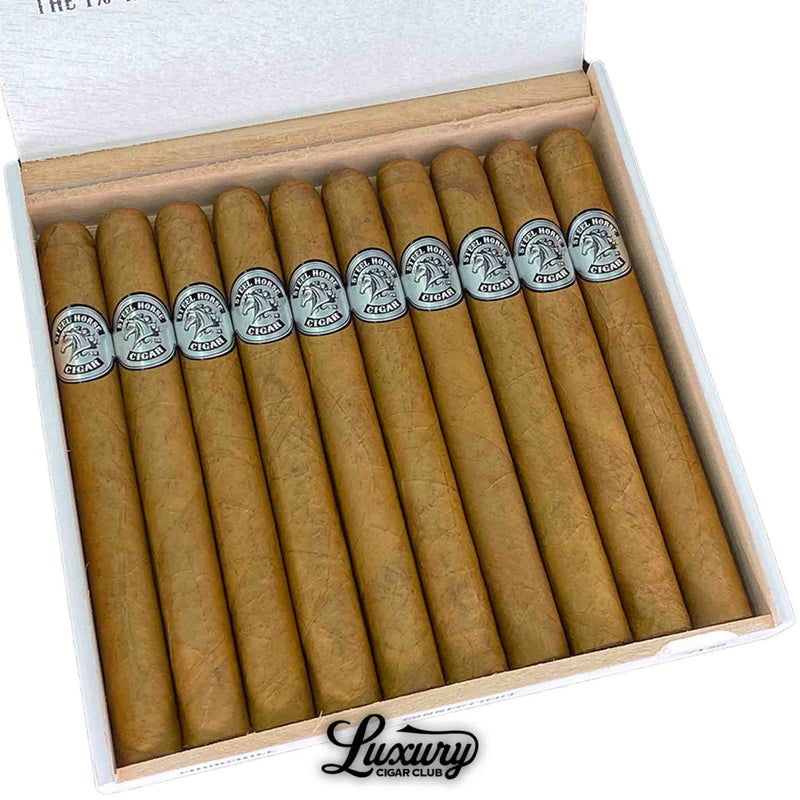 Close-up of Steel Horse Connecticut Churchill cigars inside an open white box, highlighting the silky Connecticut wrappers and silver Steel Horse logo bands. The cigars are expertly rolled and precisely aligned, reflecting artisanal craftsmanship. Luxury Cigar Club.
