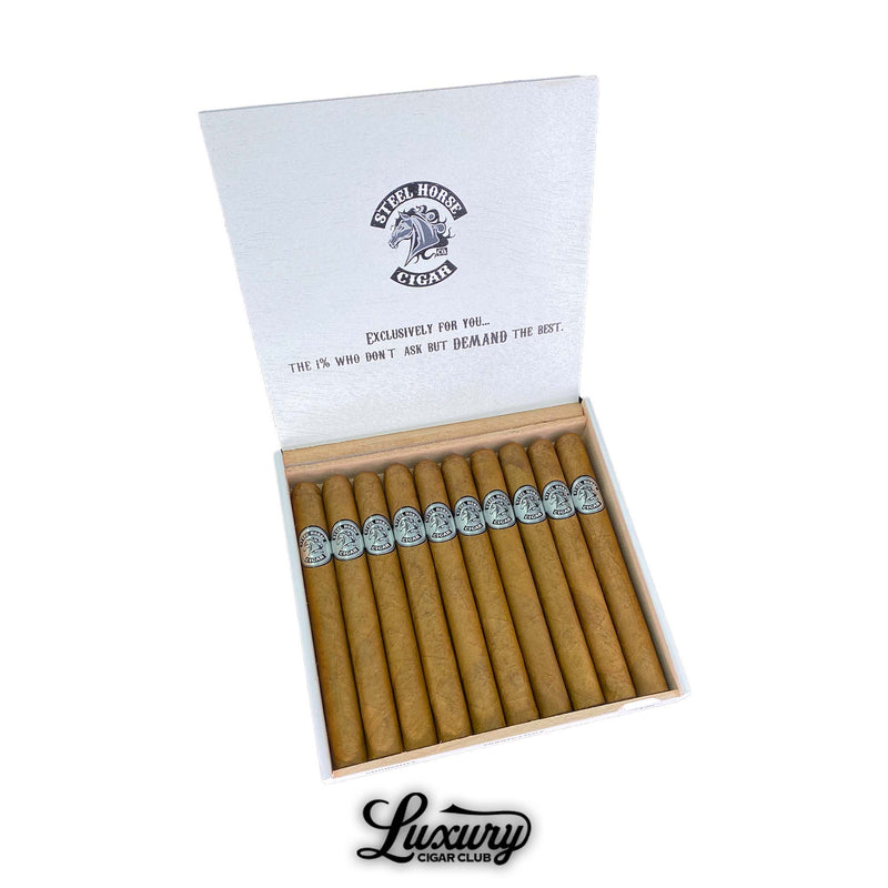 Open white box of Steel Horse Connecticut Churchill cigars, neatly arranged with smooth golden-brown wrappers and silver bands featuring the Steel Horse logo. The inside lid displays the phrase “Exclusively for you… The 1% who don’t ask but demand the best.” A refined presentation of premium Connecticut cigars. Luxury Cigar Club.