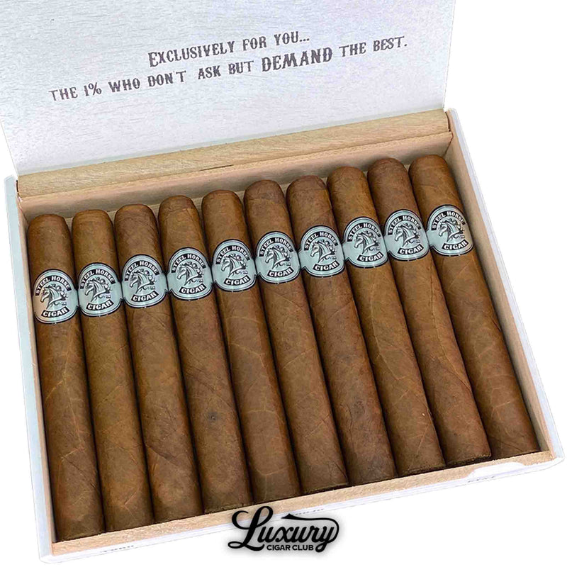 Close-up of Steel Horse Connecticut Toro cigars in an open box, emphasizing the smooth, golden-brown Connecticut wrappers and detailed silver Steel Horse logo bands. Each cigar is meticulously crafted and evenly packed. Luxury Cigar Club.