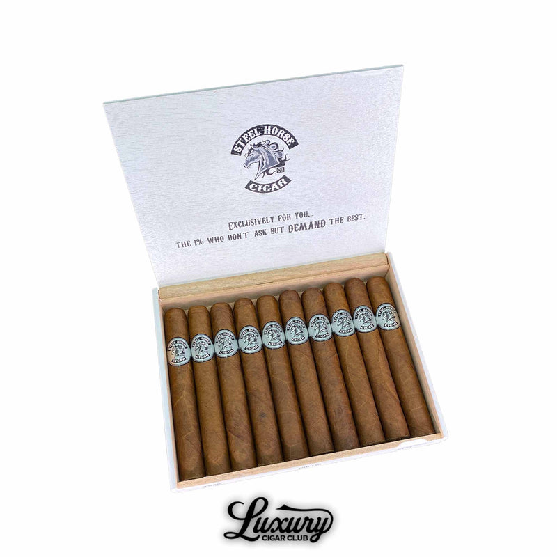 Open box of Steel Horse Connecticut Toro cigars featuring golden Connecticut wrappers with silver embossed bands. The interior lid reads, “Exclusively for you… The 1% who don’t ask but demand the best,” showcasing a sophisticated, boutique presentation. Luxury Cigar Club.
