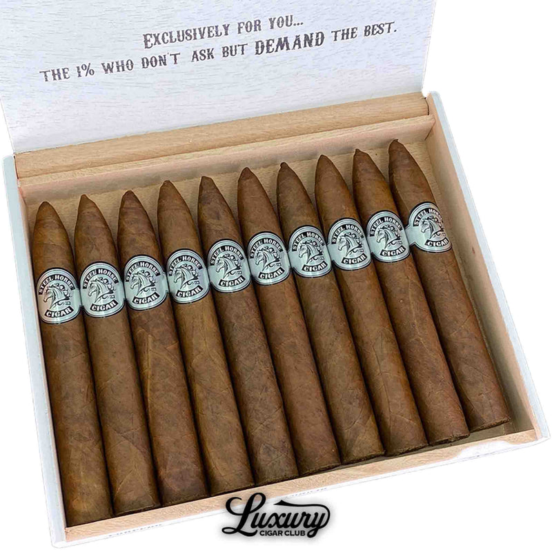 Close-up of Steel Horse Connecticut Torpedo cigars inside their white wooden box, showcasing the flawless torpedo shape and smooth, light Connecticut wrappers accented with silver bands. A premium handcrafted presentation. Luxury Cigar Club.