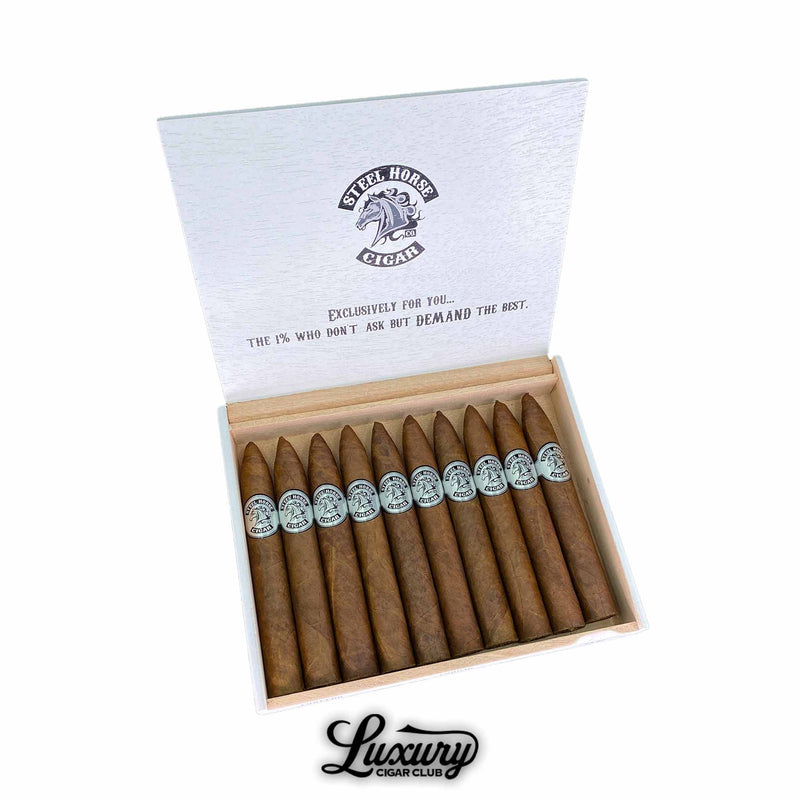 Open box of Steel Horse Connecticut Torpedo cigars displaying pointed heads and golden Connecticut wrappers with silver Steel Horse logo bands. The inside lid features the brand’s statement of excellence, highlighting luxury and precision. Luxury Cigar Club.