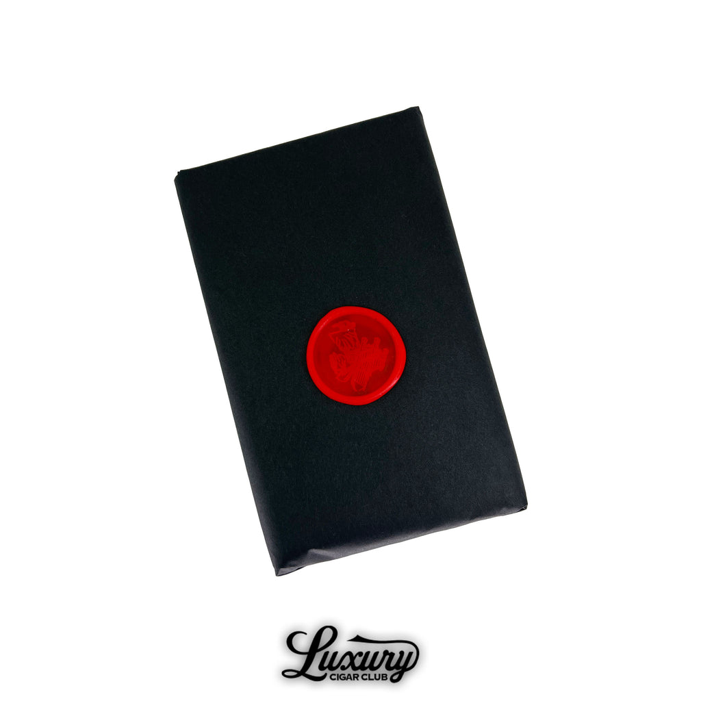 Black wrapped bundle of Stolen Throne Crook of the Crown Toro cigars sealed with a bold red wax emblem symbolizing exclusivity from Luxury Cigar Club.
