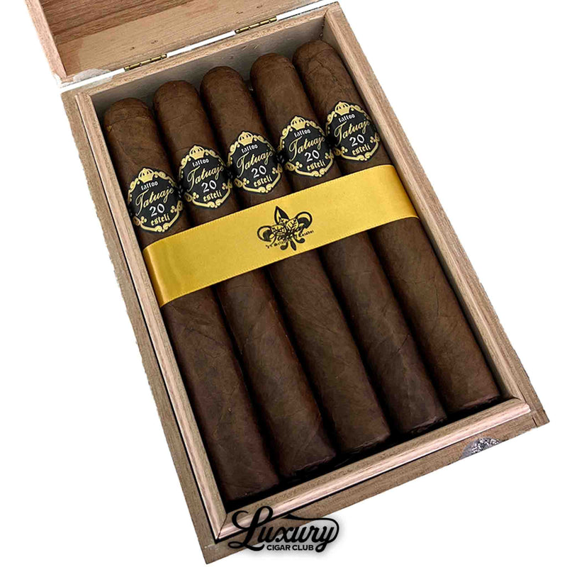 close up of tatuaje 20th anniversary grand chasseur cigars in the luxury cigar club box showing the dark brown wrapper and black and gold bands