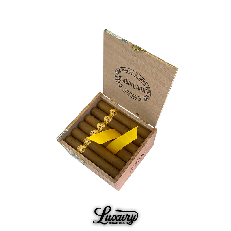 Tatuaje Cabaiguan Robusto Extra cigars arranged in a natural cedar box with embossed logo on the lid and golden bands on each cigar, finished with a yellow ribbon, presented by Luxury Cigar Club.