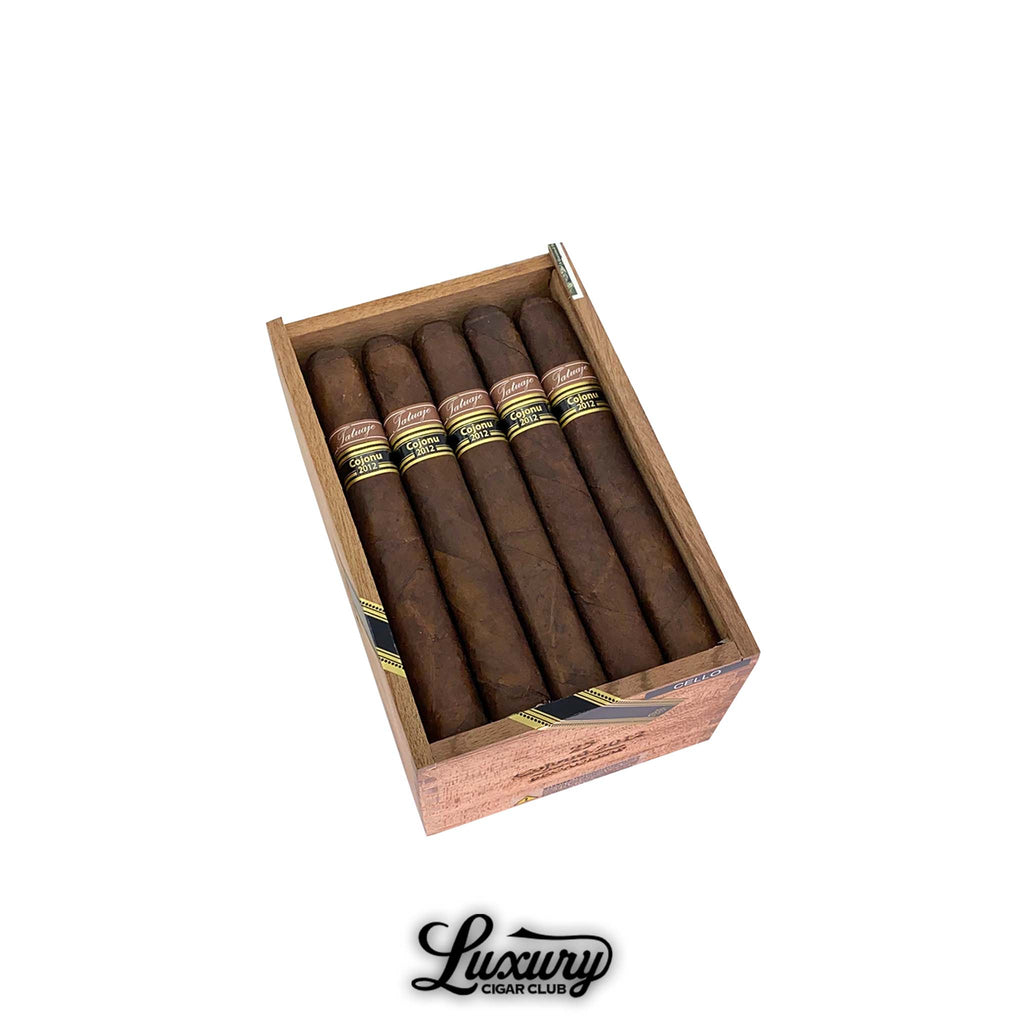 Open wooden box of Tatuaje Cojonu 2012 Broadleaf cigars displayed at Luxury Cigar Club