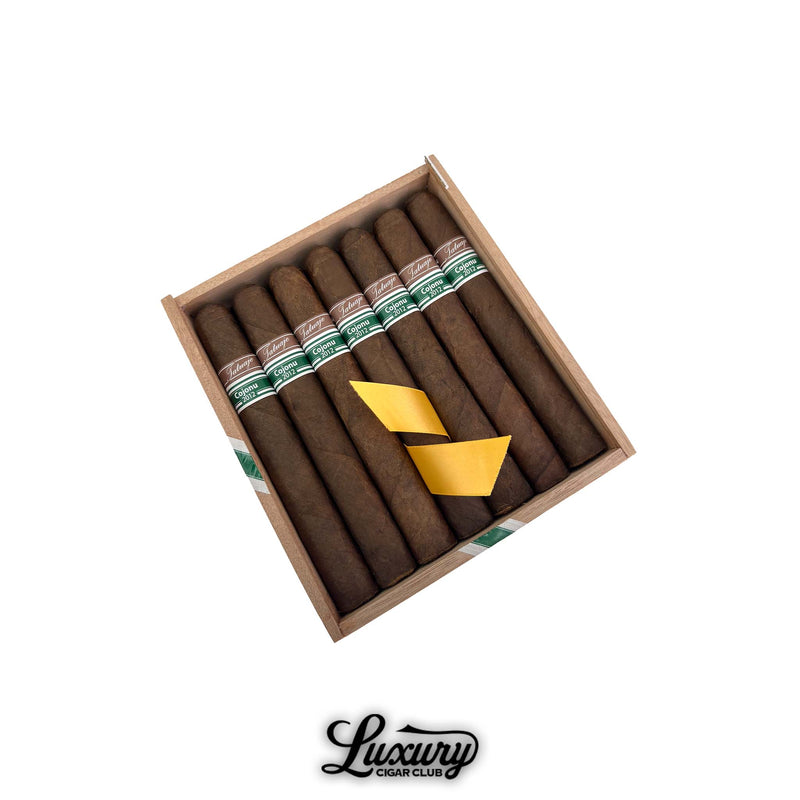 Open wooden box of Tatuaje Cojonu 2012 Tuxtla cigars with green banding at Luxury Cigar Club