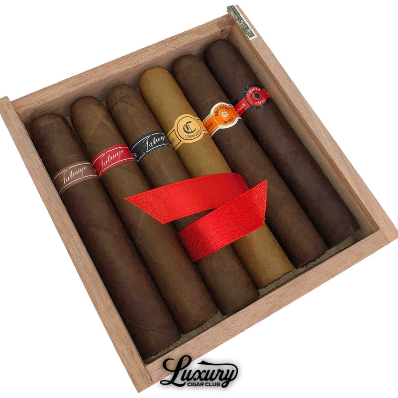 Close-up of Tatuaje Colecciones Robusto Exclusivos cigars showing detailed bands and craftsmanship, displayed by Luxury Cigar Club.