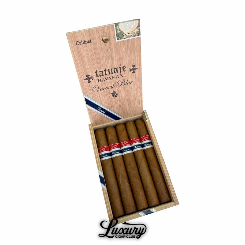 Open wooden box featuring five Tatuaje Havana VI Verocu Blue No. 1 cigars, each with a smooth light brown wrapper and red-and-blue Verocu bands. The box lid is marked with “Tatuaje Havana VI Verocu Blue” branding and a diagonal navy ribbon. The Luxury Cigar Club logo is shown beneath the box.