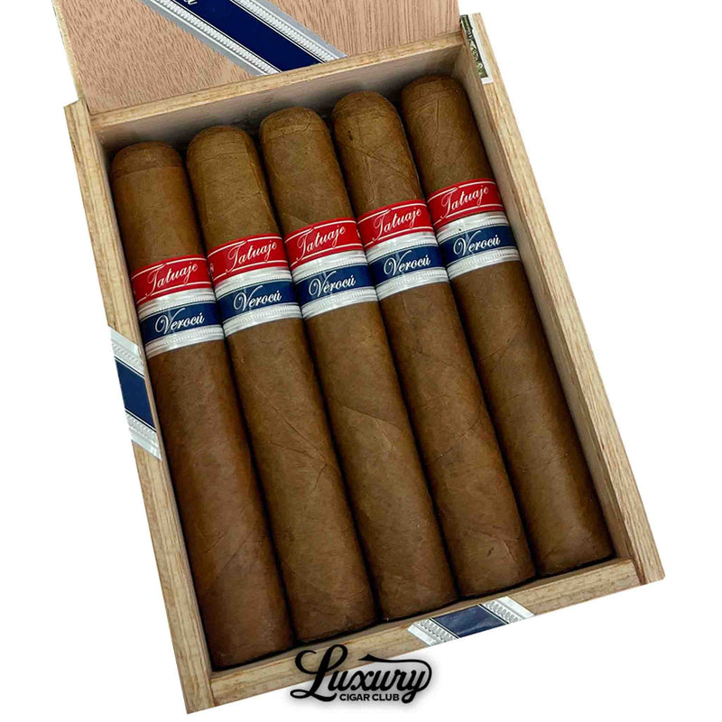 Close-up of a wooden box displaying five Tatuaje Havana VI Verocu Blue No. 2 cigars. Each cigar has a smooth, light brown wrapper and is dressed with dual red and blue Verocu bands. The cigars are neatly aligned above the Luxury Cigar Club logo.