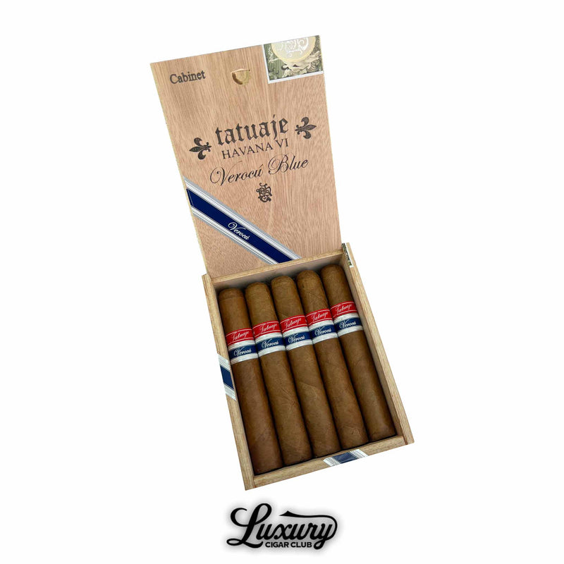 Open wooden box containing five Tatuaje Havana VI Verocu Blue No. 2 cigars, each wrapped in a light brown leaf and banded with red and blue labels. The box lid is stamped with “Tatuaje Havana VI Verocu Blue” branding and a decorative diagonal navy ribbon. Luxury Cigar Club logo is displayed below the box.