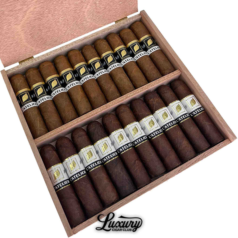 Close up of Tatuaje L’Atelier Roxy cigars inside the wooden box, highlighting the mixed wrapper band colors and detailed cigar texture with the Luxury Cigar Club logo visible.