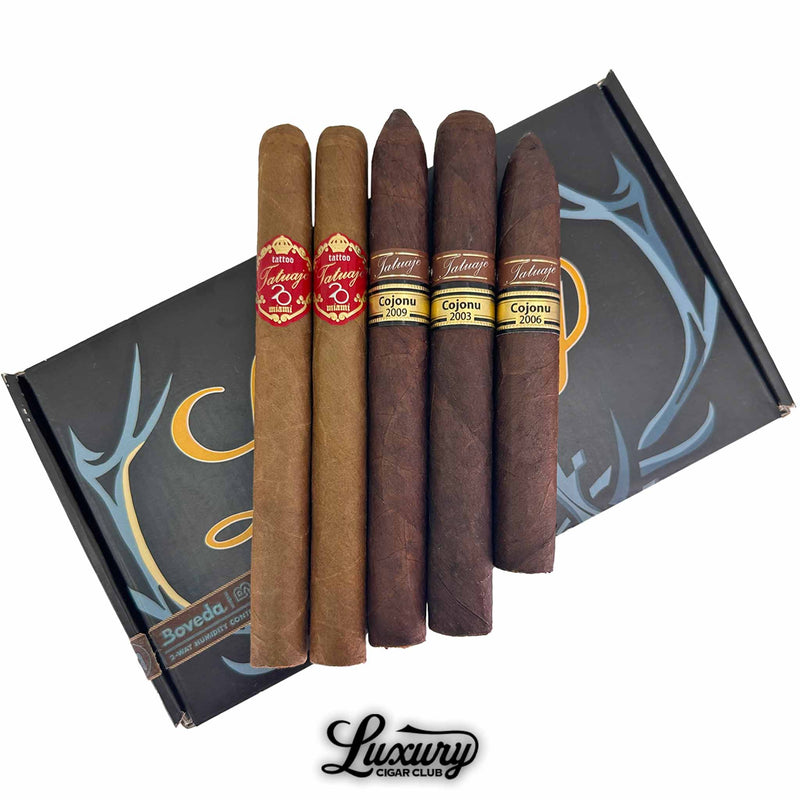 Close-Up of Tatuaje Legends and Legacy Sampler with Luxury Cigar Club Logo. Detailed view of five Tatuaje cigars from the Legends and Legacy Sampler resting on a black sampler box with bold band designs.