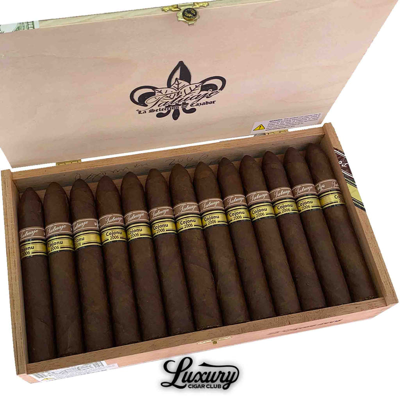 Close-up of open box Tatuaje Miami Cojonu 2006 cigars showing dark wrappers and Luxury Cigar Club logo