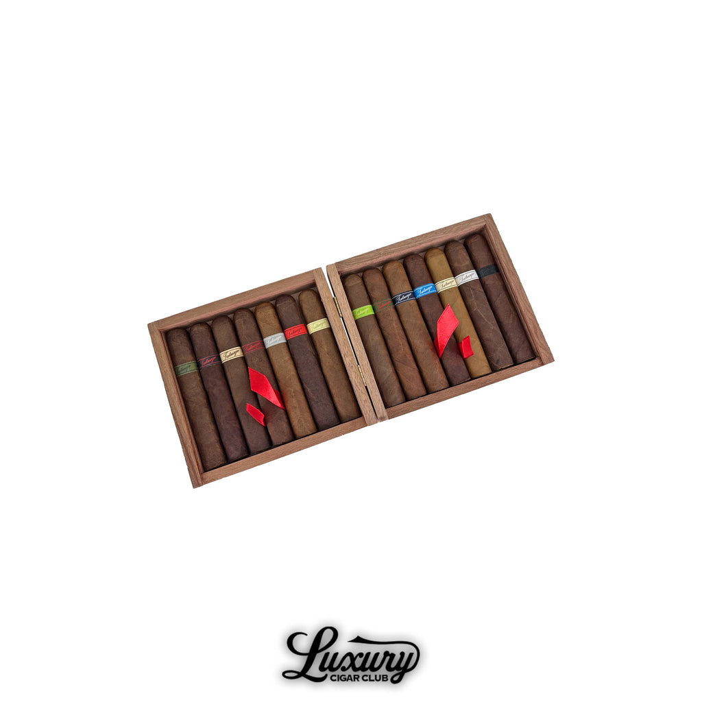 Open wooden box set of Tatuaje Monster Smash Limited Edition cigars, featuring two compartments filled with cigars wrapped in varied colored bands representing different monster themes. Luxury Cigar Club branding below.