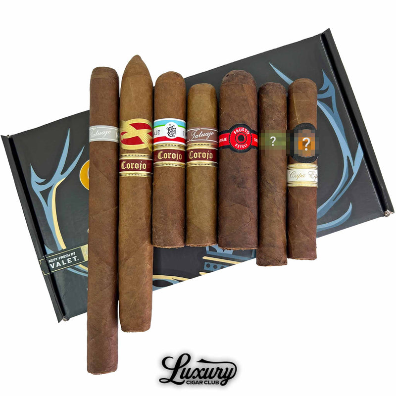 Close up of the Tatuaje Monsters and Legends sampler showing mixed Tatuaje Corojo cigars and limited edition blends arranged on a Luxury Cigar Club box