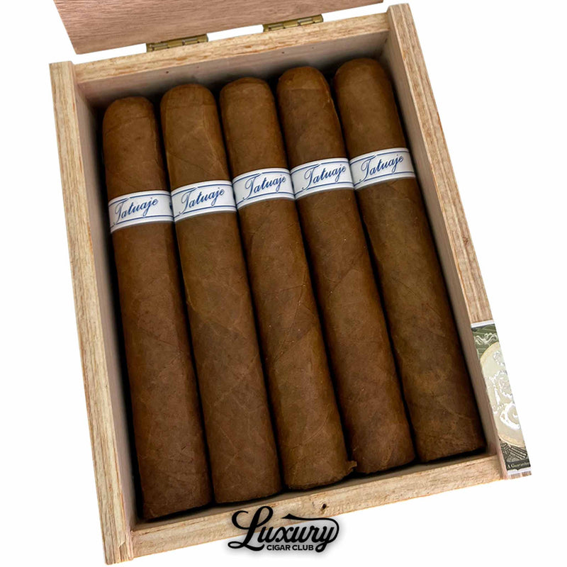 Close up inside the box of Tatuaje Series P Honduras Robusto cigars showing wrapper texture and color variation in the cedar tray Luxury Cigar Club branding