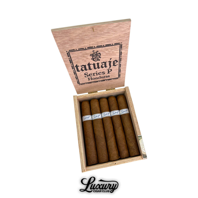 Open box of Tatuaje Series P Honduras Robusto cigars with natural claro wrappers arranged in a cedar box shot from above on white background Luxury Cigar Club branding